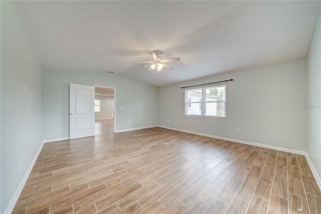 5338 Frank Hough Road Panama City, FL 32404 - Photo 22 of 29 wooden floor in an empty room with a window