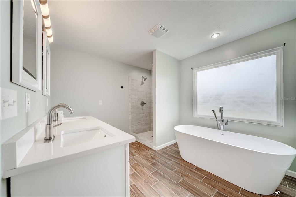 5338 Frank Hough Road Panama City, FL 32404 - Photo 23 of 29 a bathroom with a sink and a large mirror