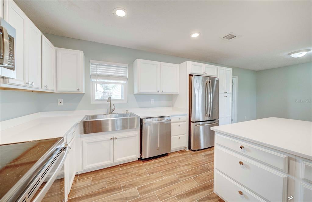 5338 Frank Hough Road Panama City, FL 32404 - Photo 10 of 29 a kitchen with a white cabinets and white appliances