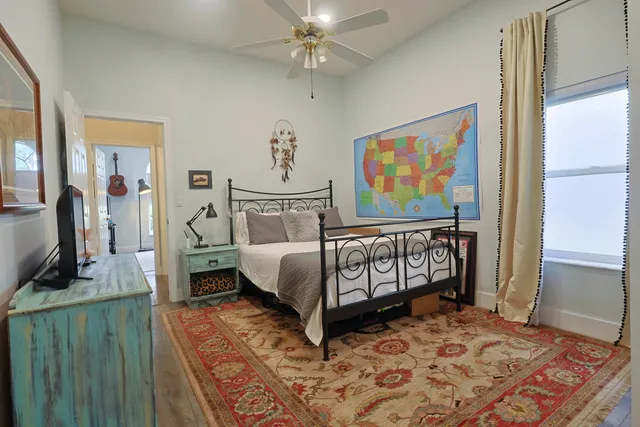 a bedroom with a bed and a window