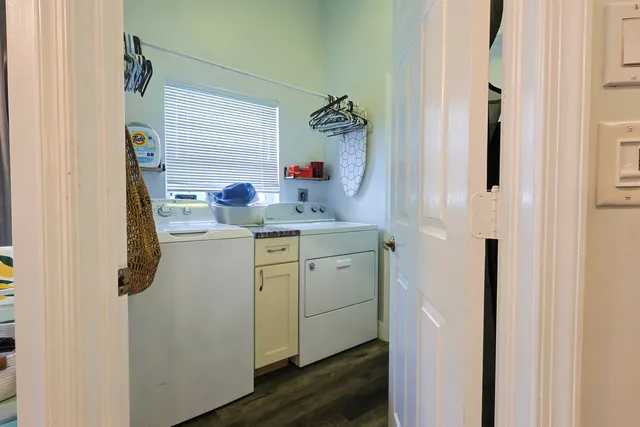a utility room with cabinets washer and dryer