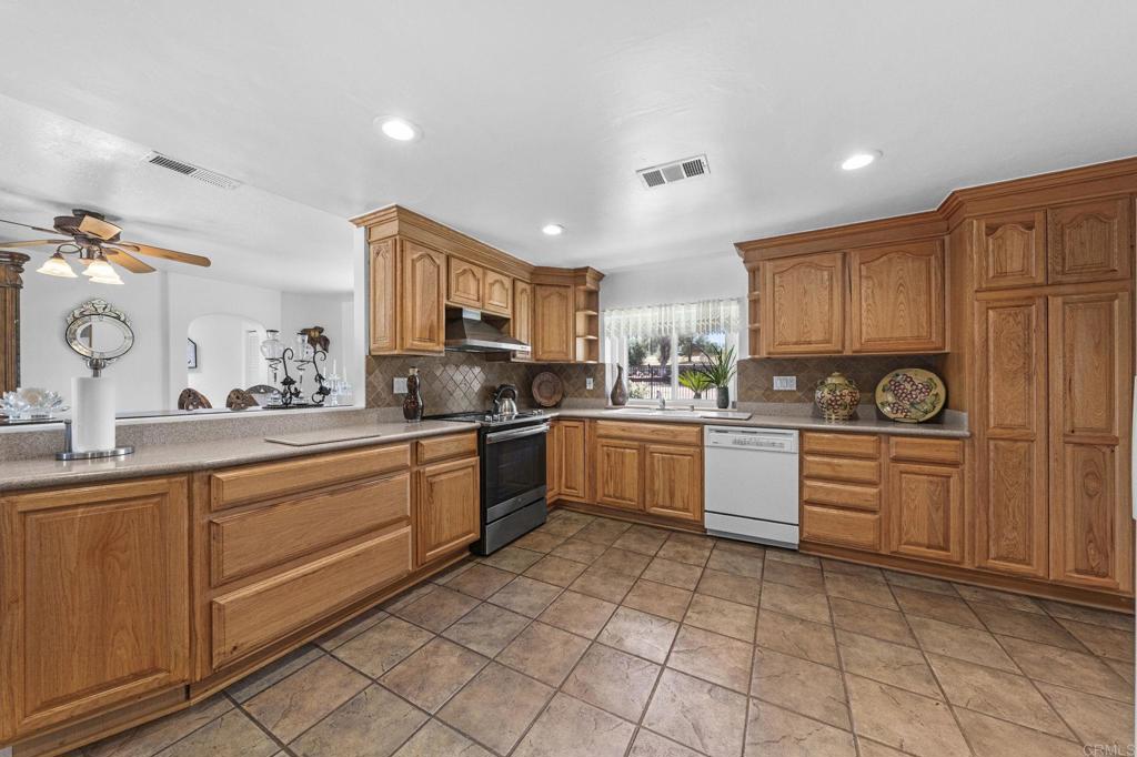 30265 Miller Road Valley Center, CA 92082 - Photo 9 of 56 a kitchen with a sink cabinets and window
