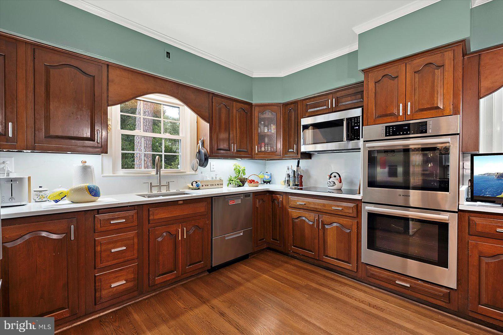 921 Riverside Drive Salisbury, MD 21801 - Photo 19 of 62 a kitchen with stainless steel appliances granite countertop a stove a sink and a microwave