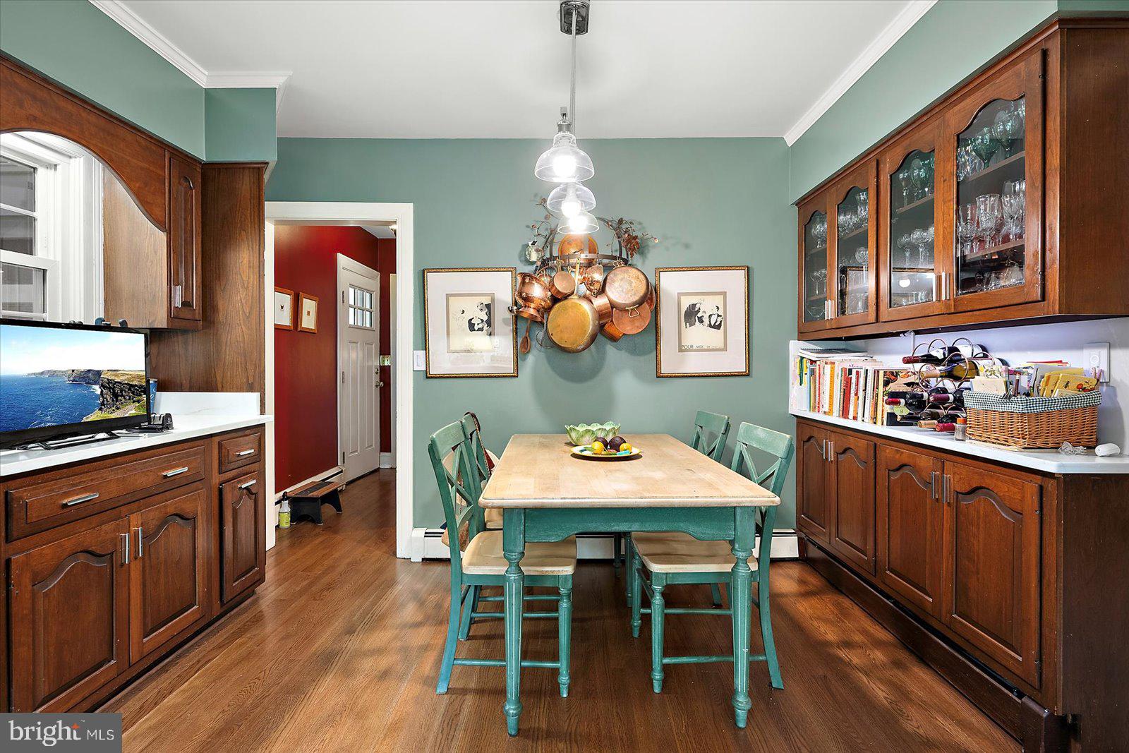 921 Riverside Drive Salisbury, MD 21801 - Photo 22 of 62 a kitchen with stainless steel appliances granite countertop a stove a refrigerator a sink a dining table and chairs with wooden floor