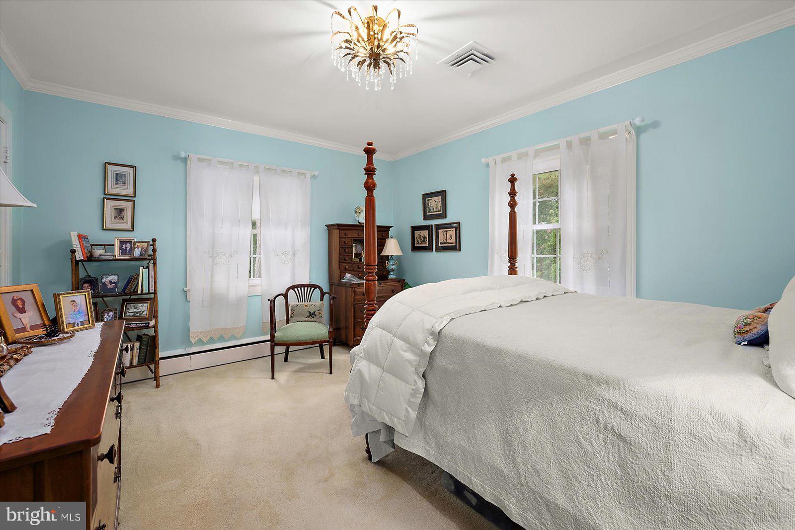 921 Riverside Drive Salisbury, MD 21801 - Photo 31 of 62 a bedroom with a bed and a chandelier