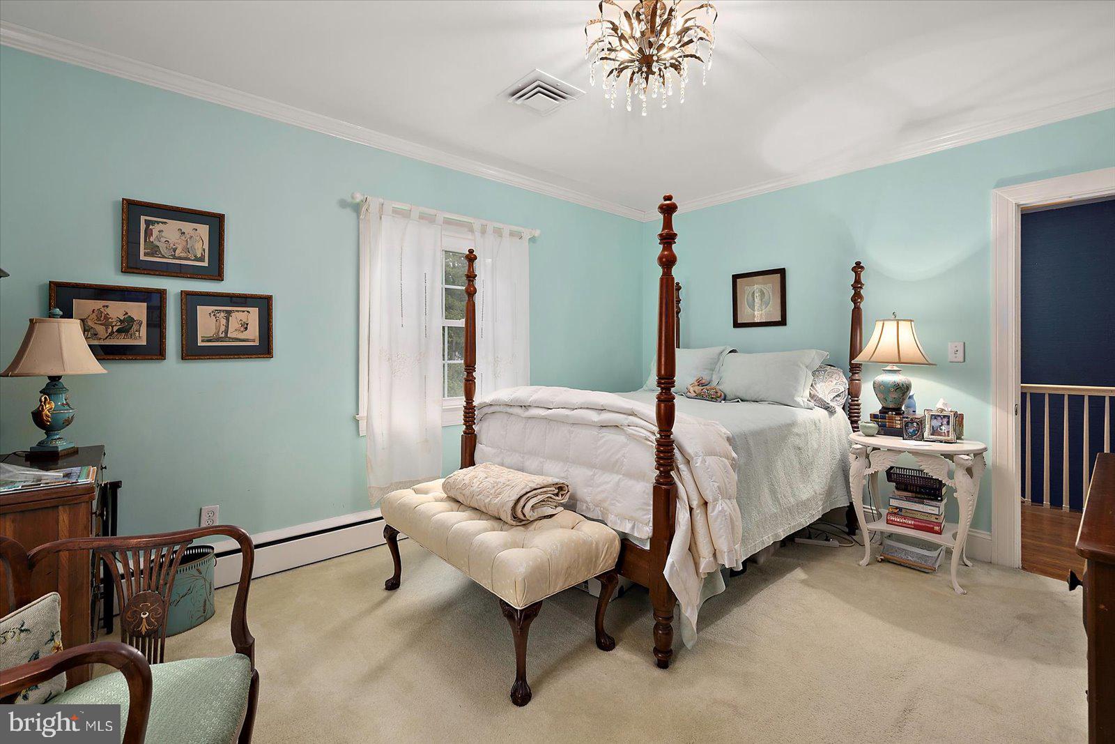 921 Riverside Drive Salisbury, MD 21801 - Photo 32 of 62 a bedroom with a bed and a chandelier