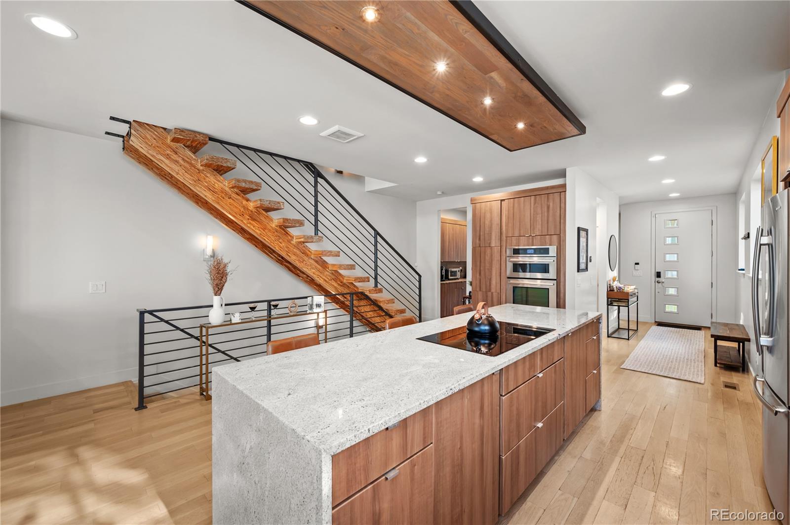 3448 West 36th Avenue Denver, CO 80211 - Photo 11 of 48 a kitchen with stainless steel appliances kitchen island granite countertop a sink and cabinets