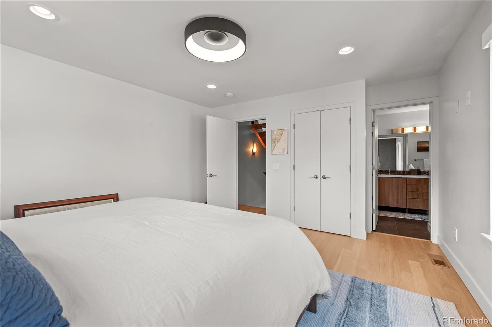 3448 West 36th Avenue Denver, CO 80211 - Photo 20 of 48 a spacious bedroom with a bed and a view of bathroom