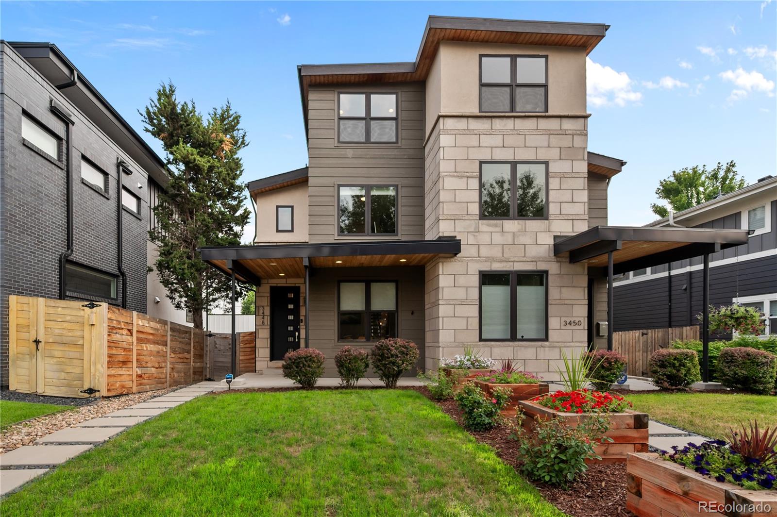 3448 West 36th Avenue Denver, CO 80211 - Photo 2 of 48 a front view of a house with a garden