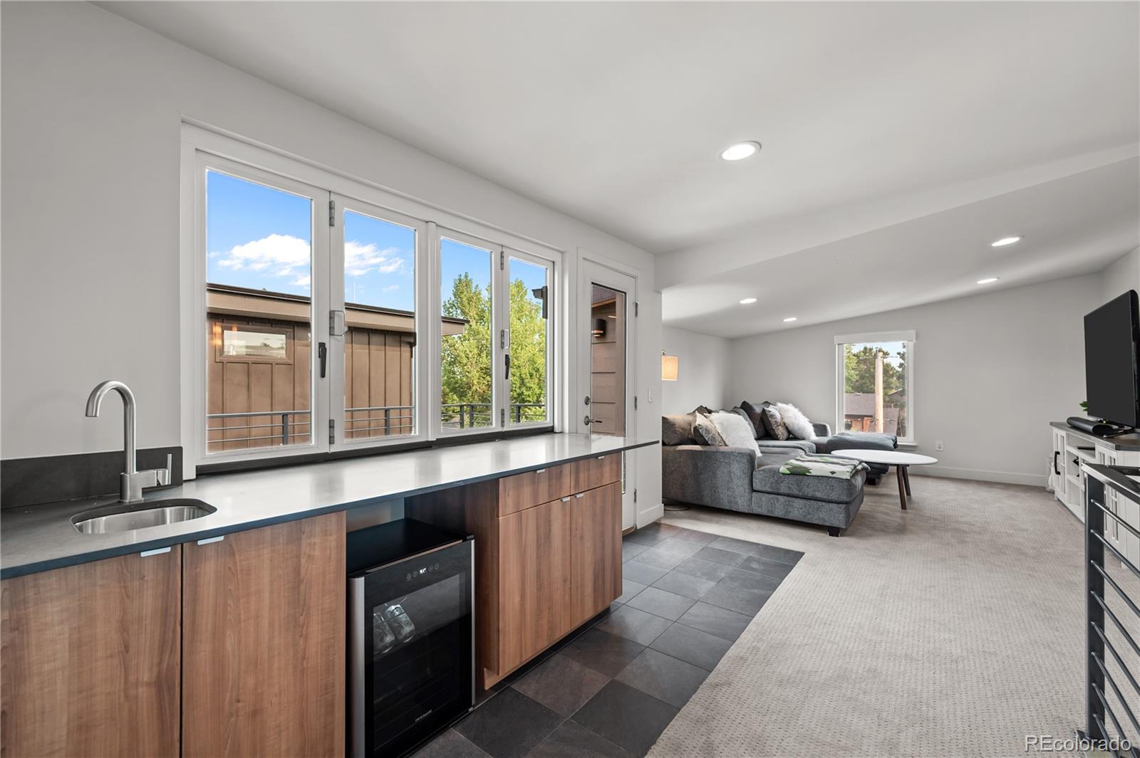 3448 West 36th Avenue Denver, CO 80211 - Photo 27 of 48 a living room with furniture and large windows