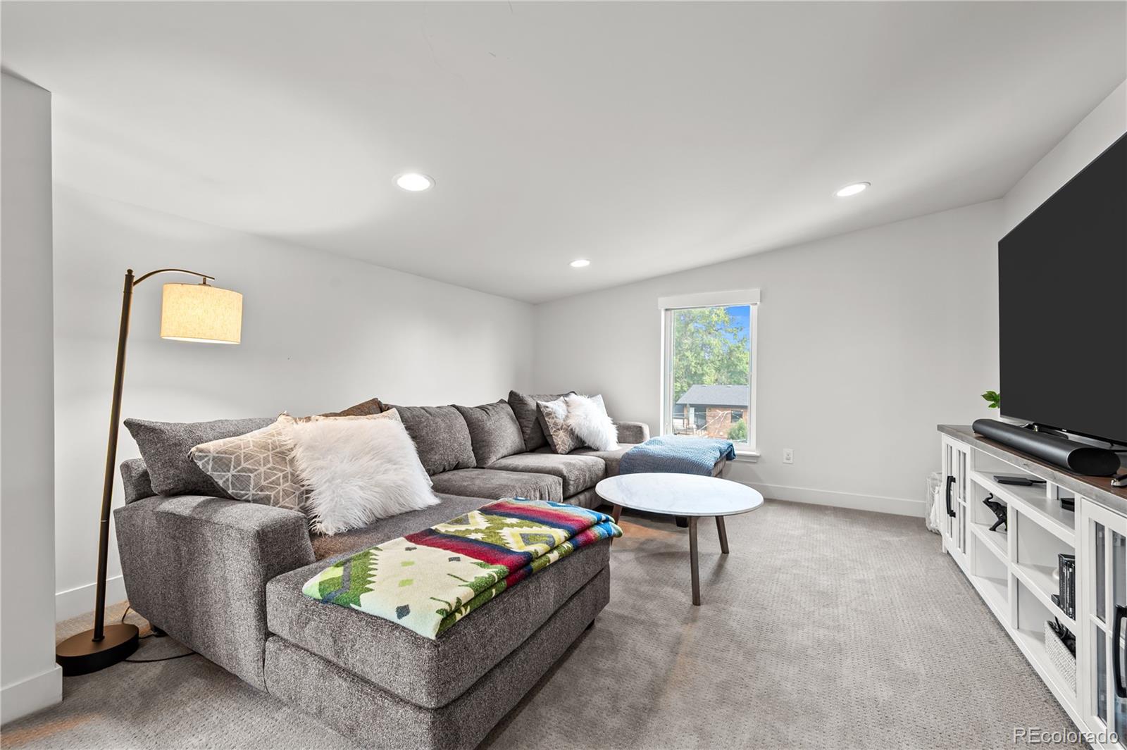3448 West 36th Avenue Denver, CO 80211 - Photo 28 of 48 a living room with furniture and a flat screen tv