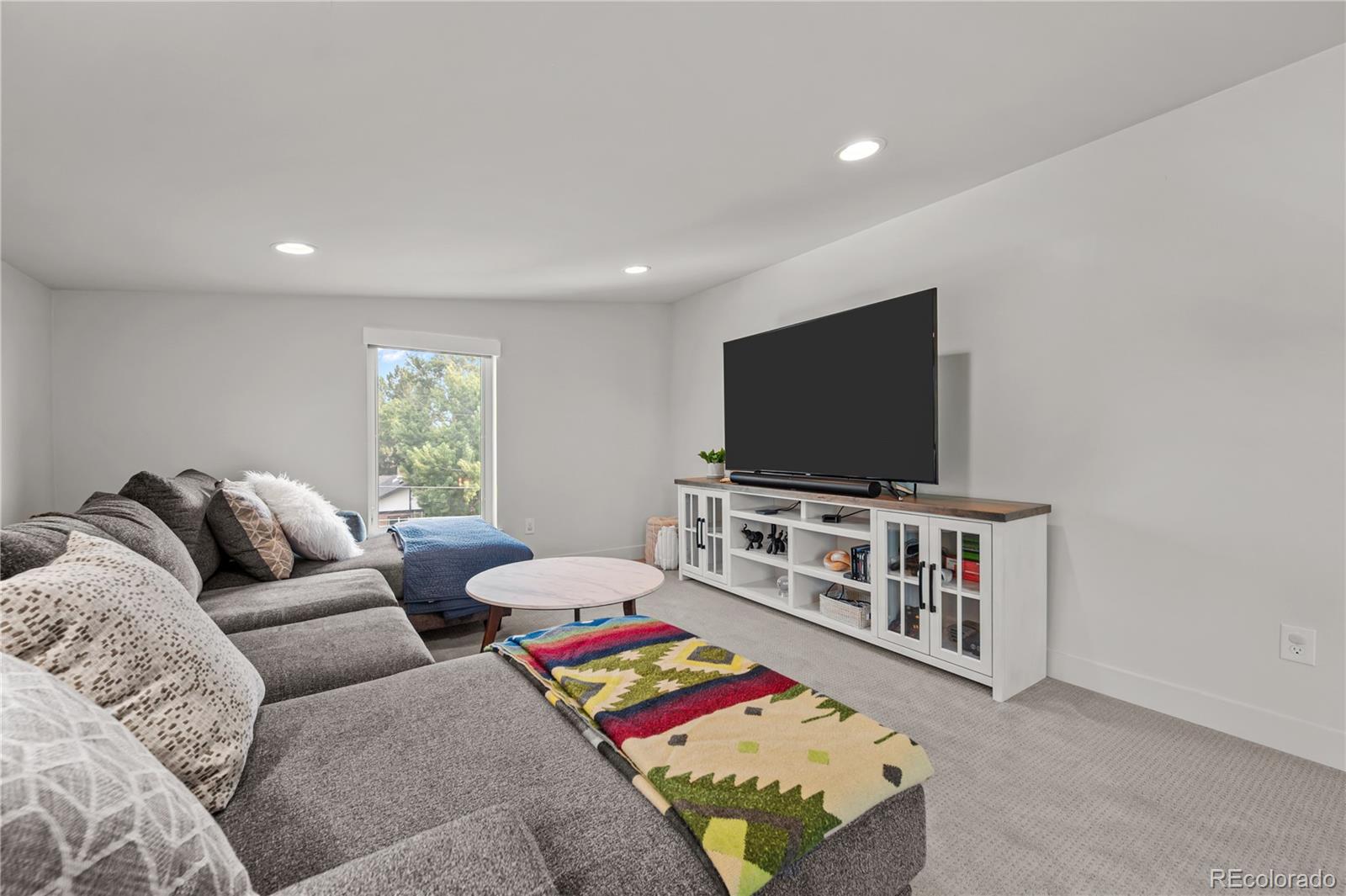 3448 West 36th Avenue Denver, CO 80211 - Photo 29 of 48 a living room with furniture and a flat screen tv