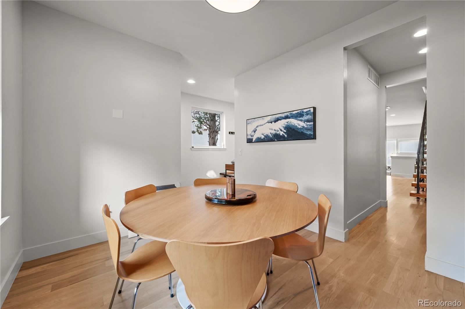 3448 West 36th Avenue Denver, CO 80211 - Photo 6 of 48 a view of a dining room with furniture and wooden floor