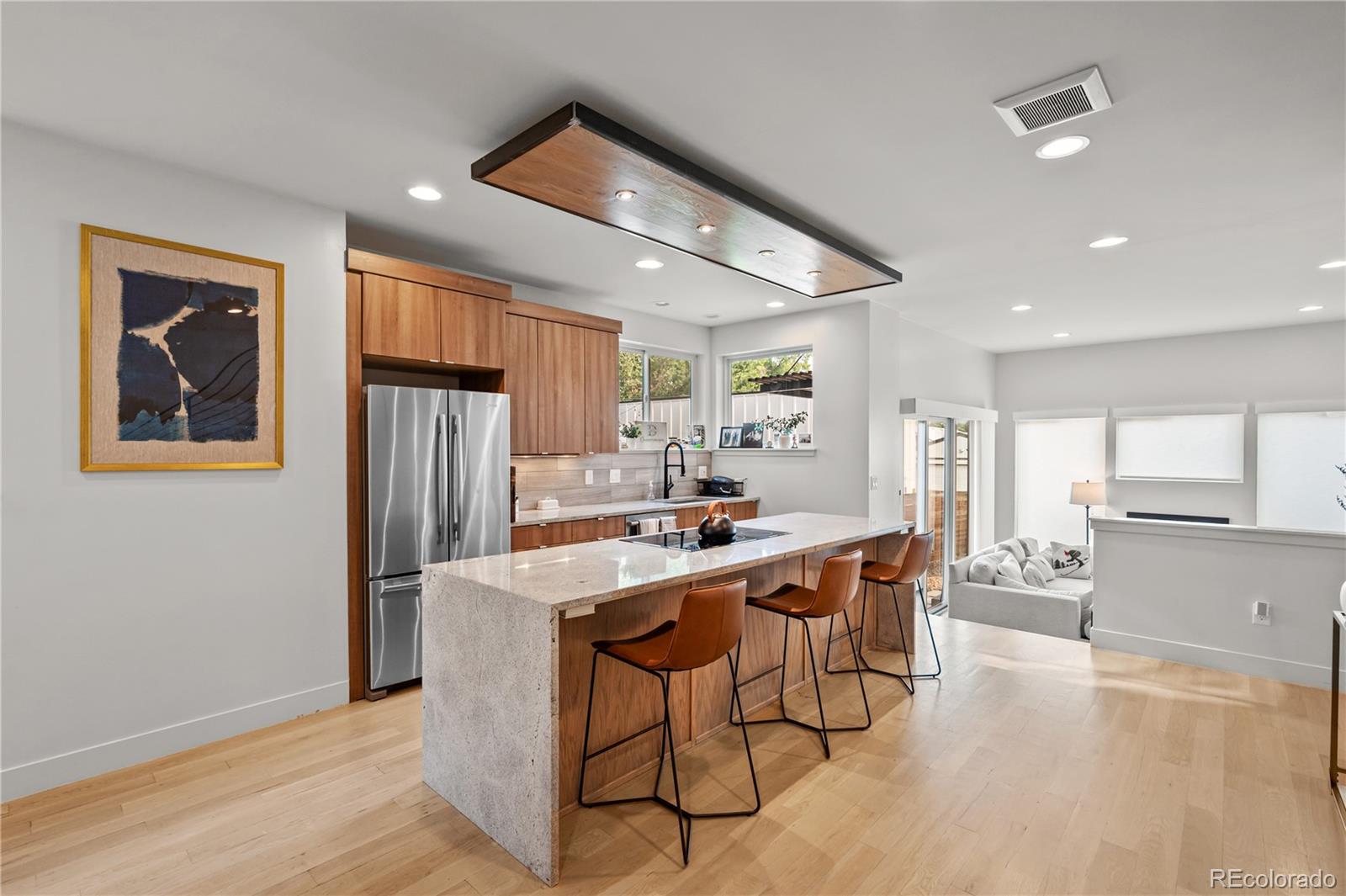 3448 West 36th Avenue Denver, CO 80211 - Photo 7 of 48 a kitchen with stainless steel appliances a dining table chairs and wooden floor
