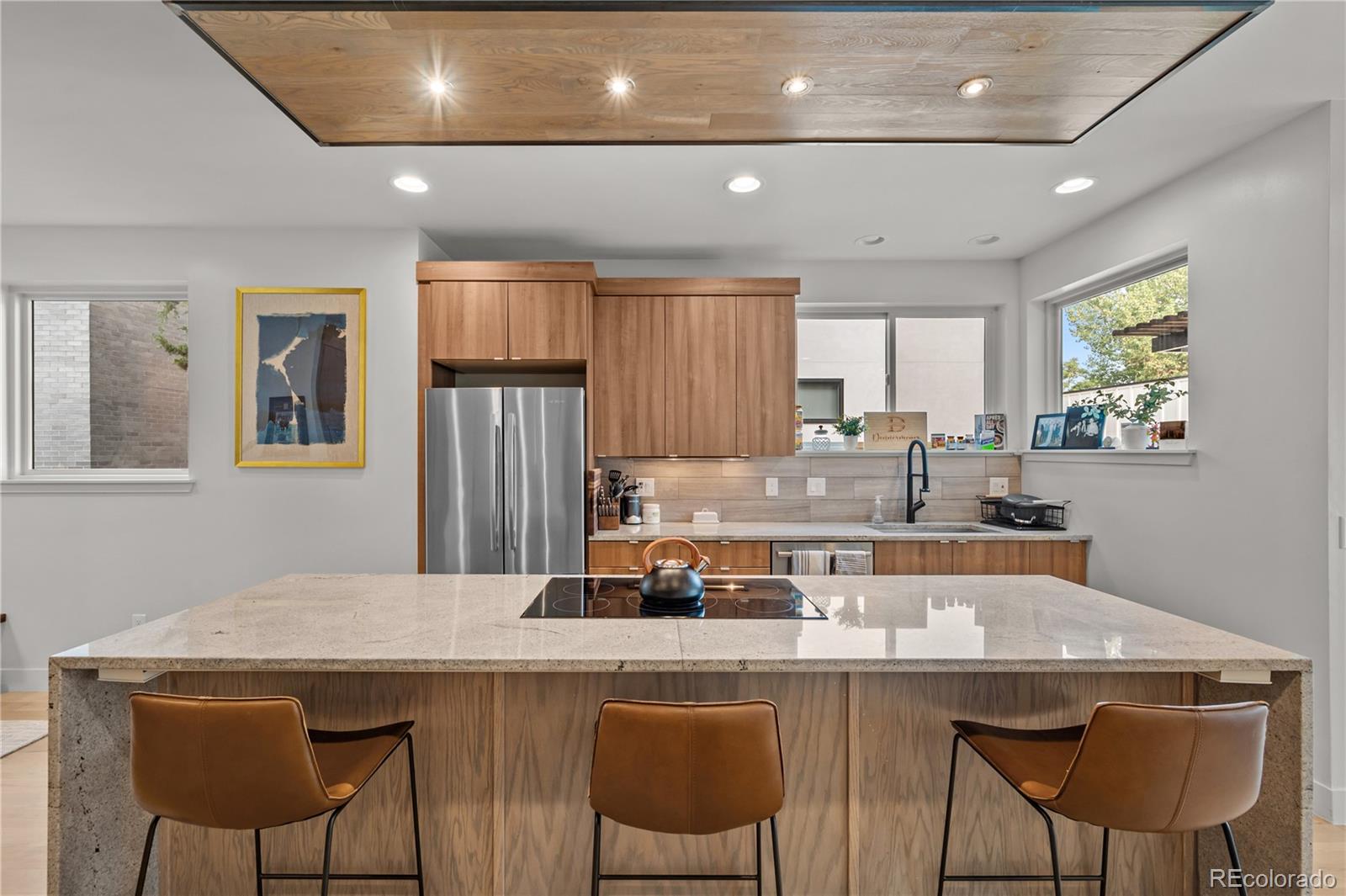 3448 West 36th Avenue Denver, CO 80211 - Photo 8 of 48 a kitchen with stainless steel appliances a dining table and chairs
