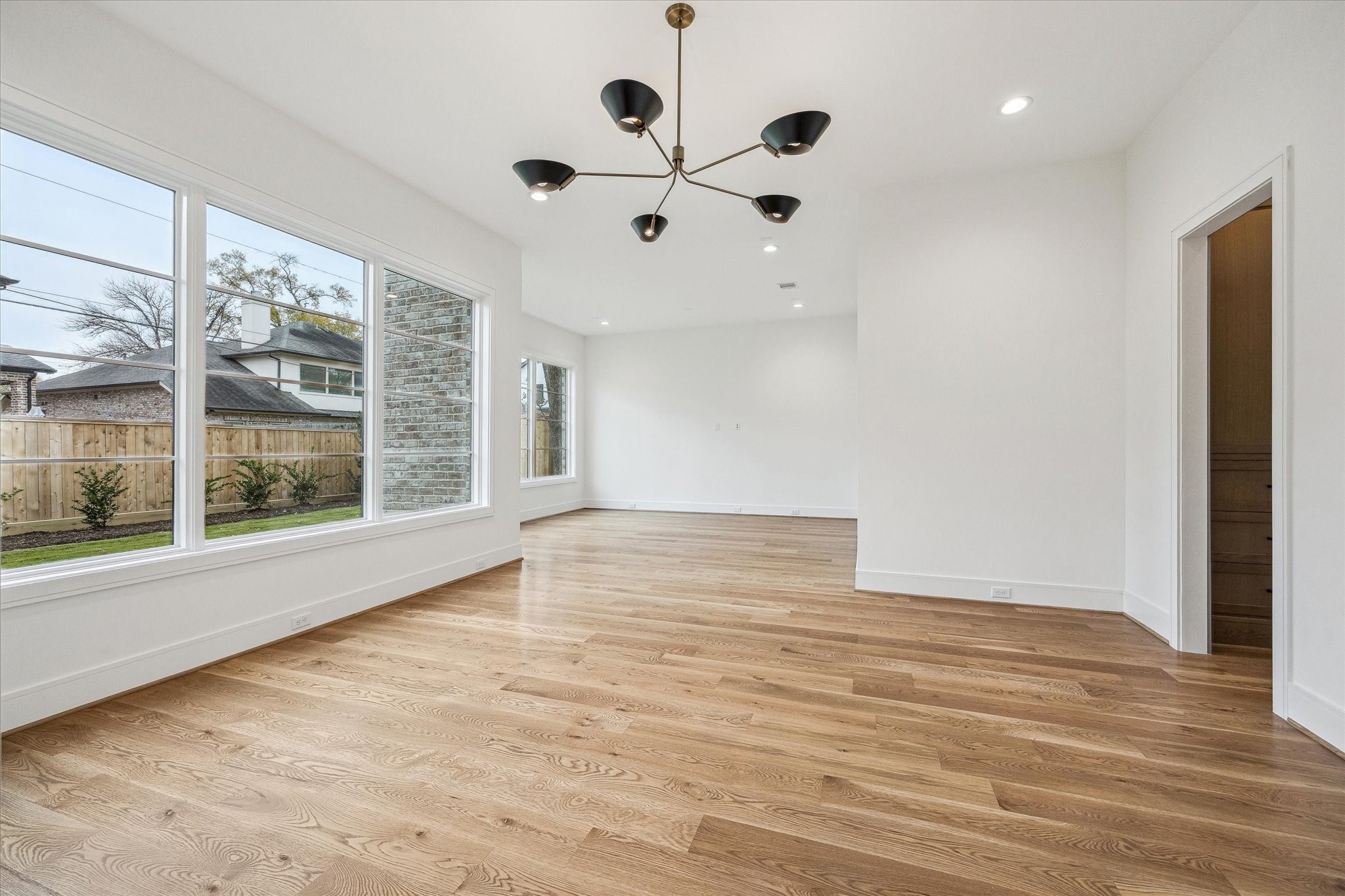 13023 Taylorcrest Road Houston, TX 77079 - Photo 15 of 49 a view of an empty room with a window and wooden floor