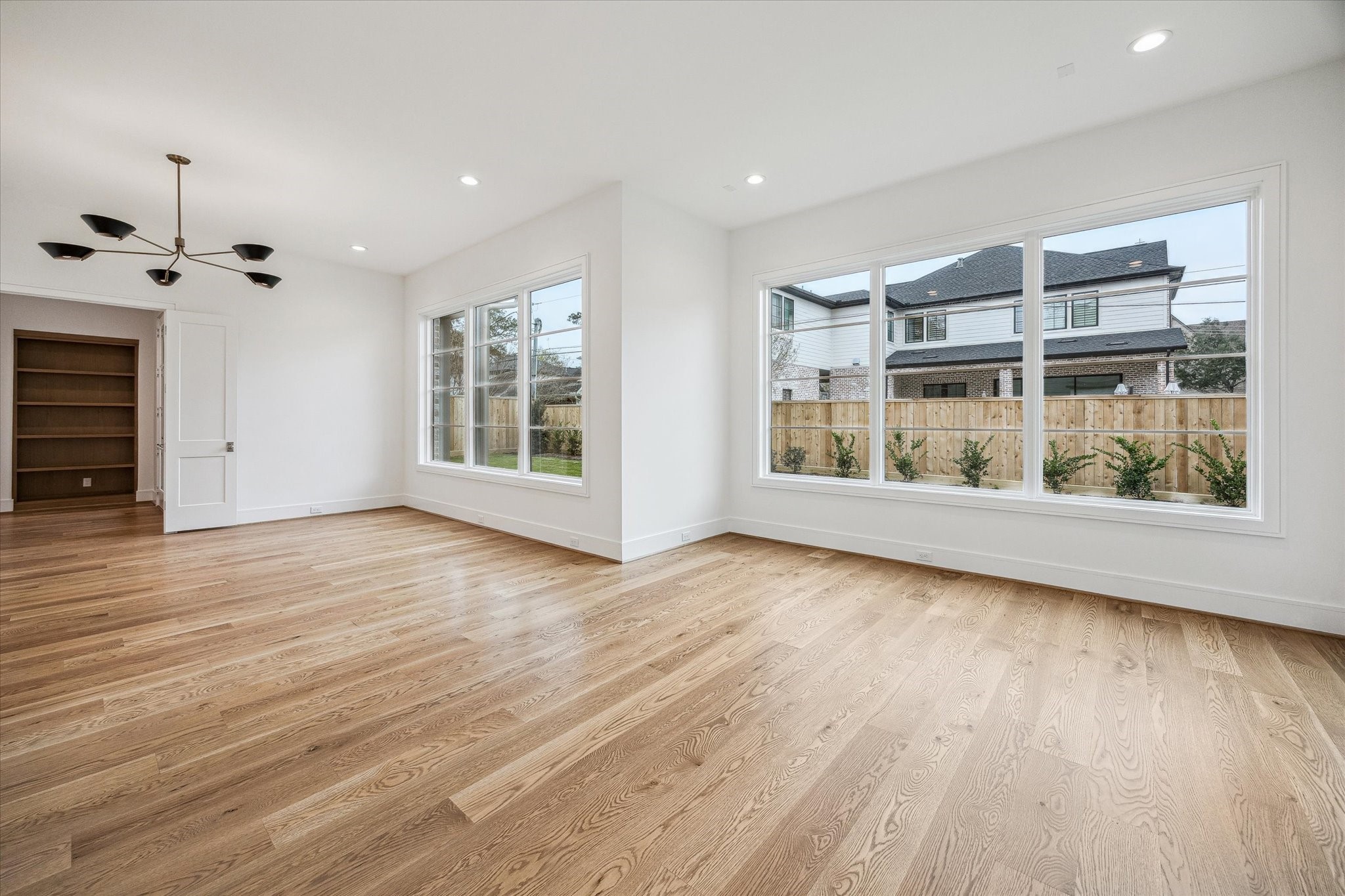 13023 Taylorcrest Road Houston, TX 77079 - Photo 16 of 49 a view of an empty room with a window and wooden floor