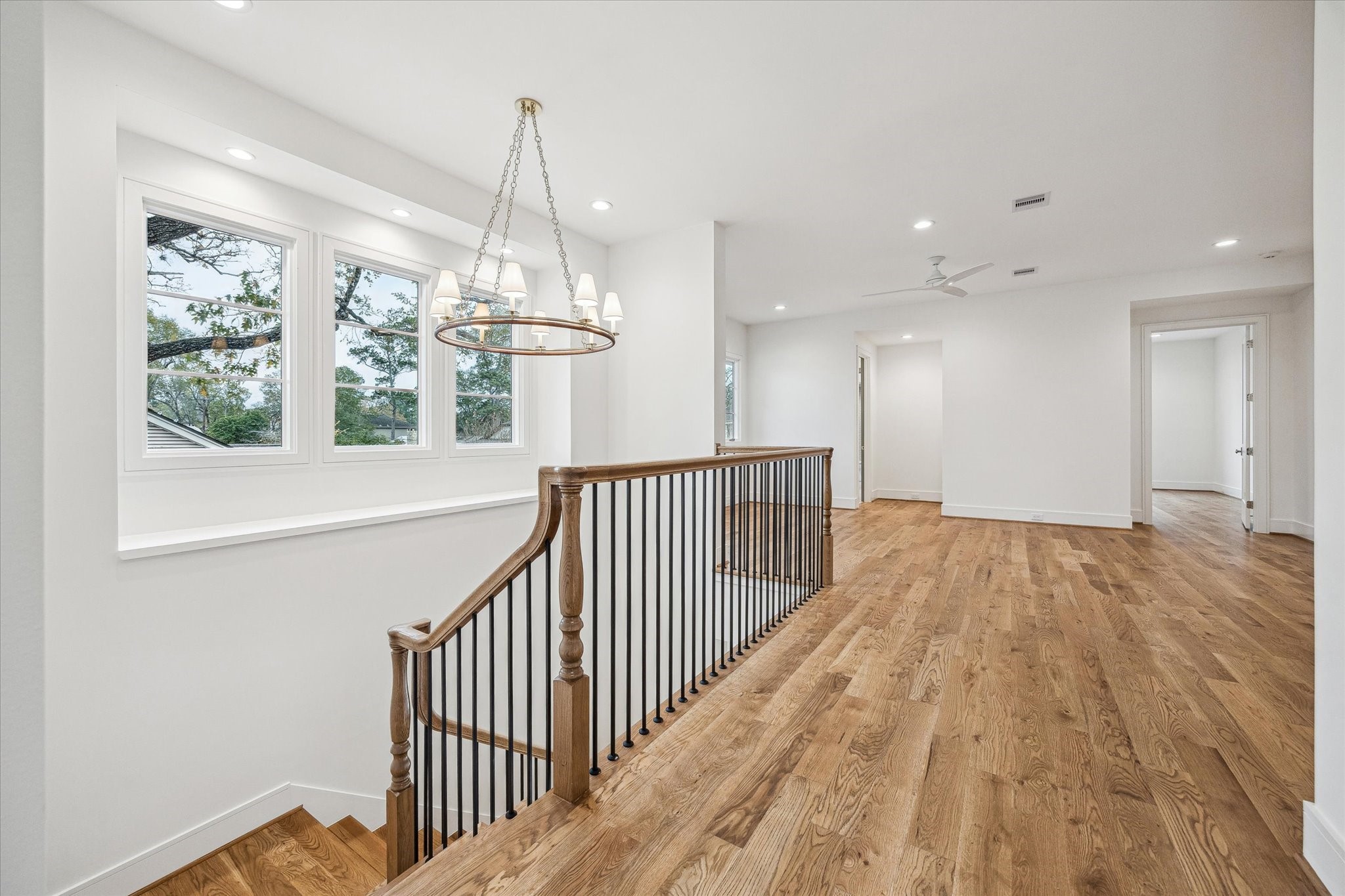 13023 Taylorcrest Road Houston, TX 77079 - Photo 24 of 49 a view of a hallway and wooden floor and chandelier