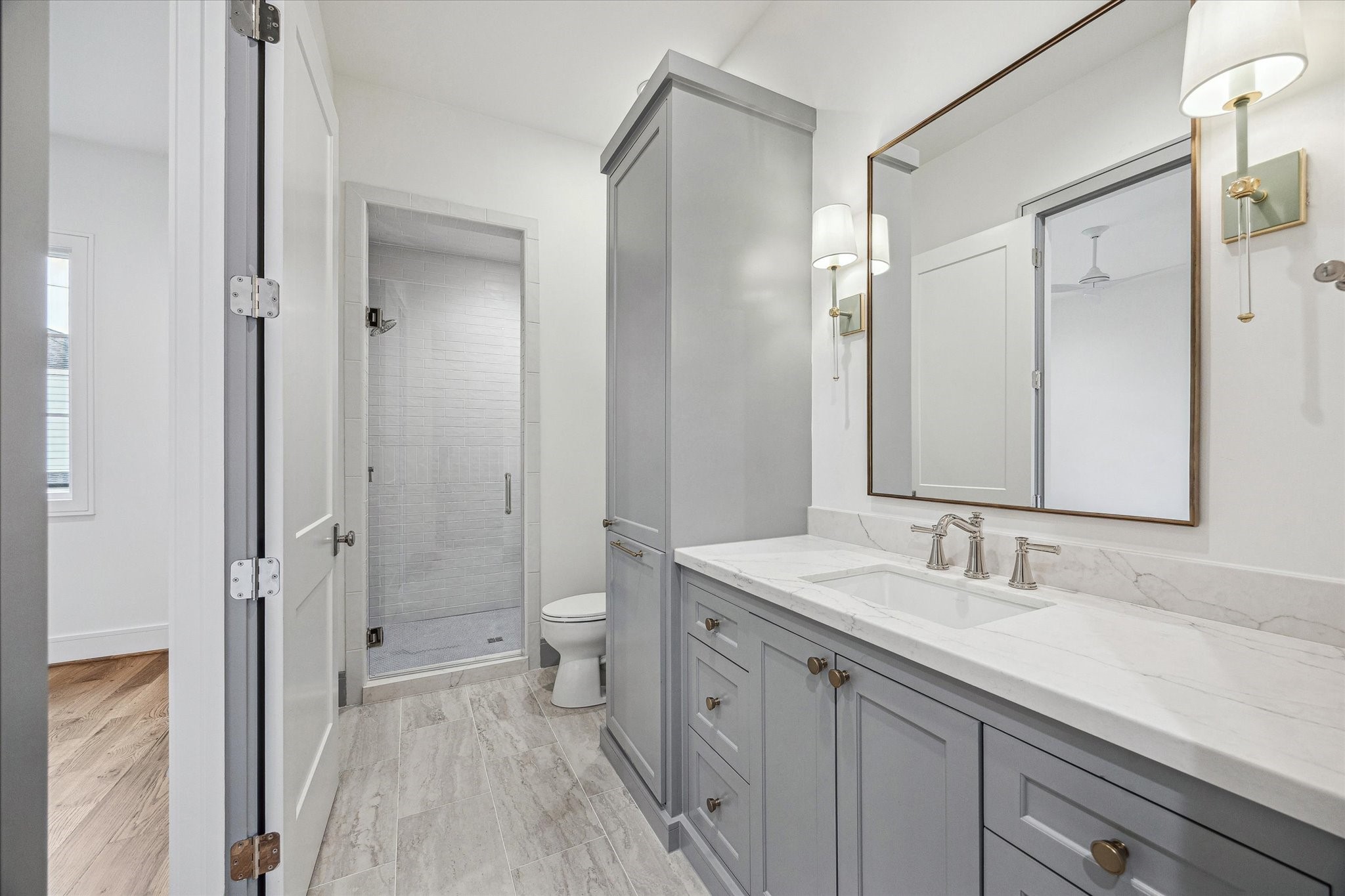 13023 Taylorcrest Road Houston, TX 77079 - Photo 40 of 49 a bathroom with a sink a toilet and a large mirror