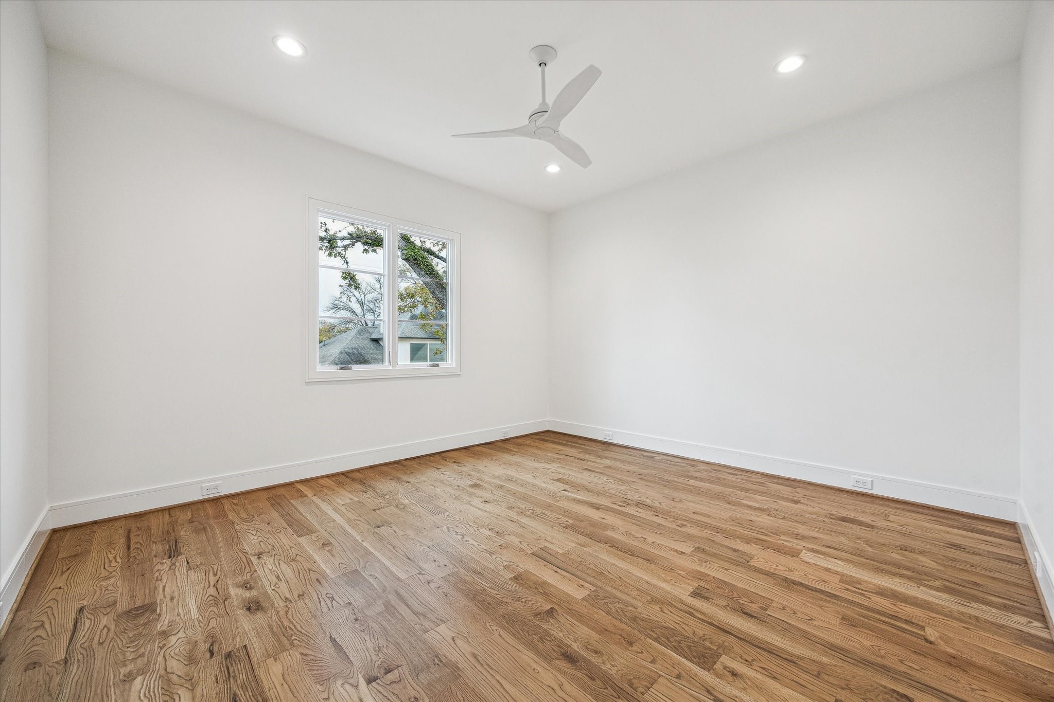 13023 Taylorcrest Road Houston, TX 77079 - Photo 41 of 49 an empty room with wooden floor ceiling fan and windows