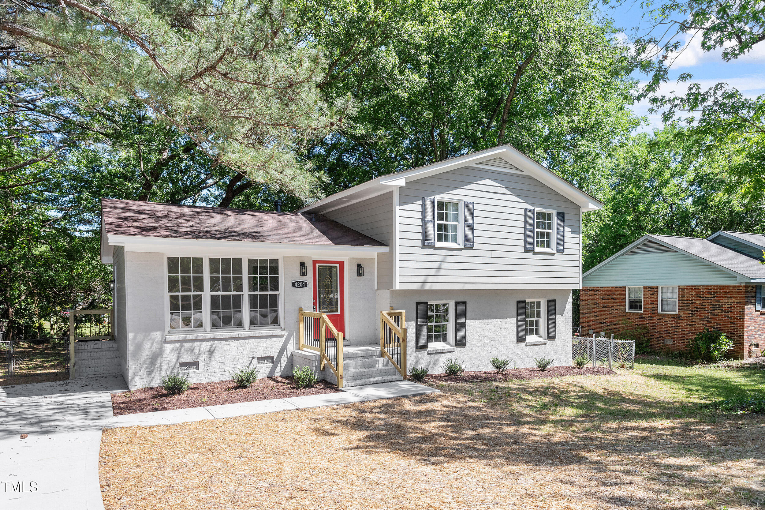 4204 Green Road Raleigh, NC 27604 - Photo 1 of 39 a front view of a house with a yard and potted plants