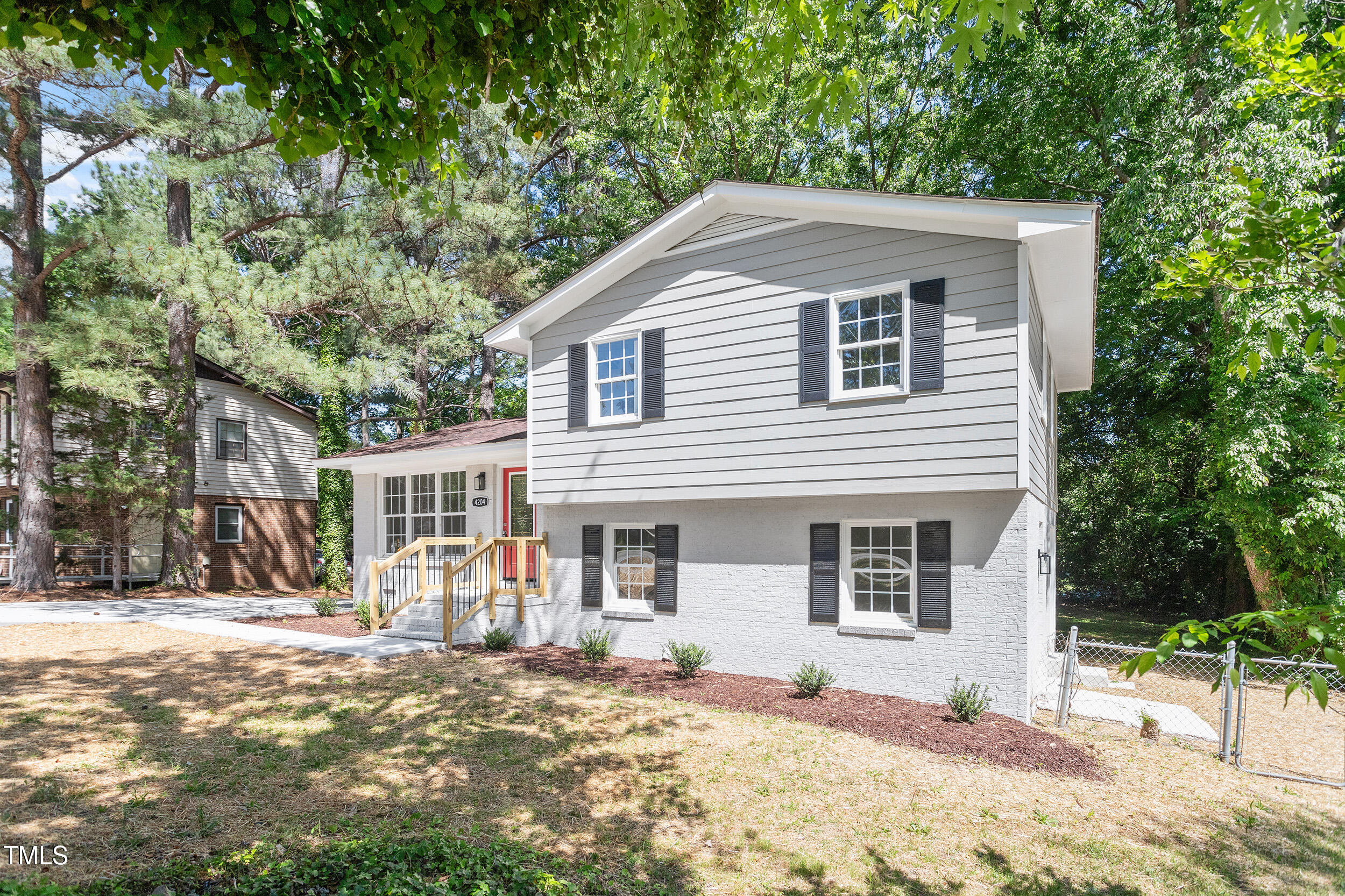 4204 Green Road Raleigh, NC 27604 - Photo 36 of 39 a front view of a house with a yard covered in snow