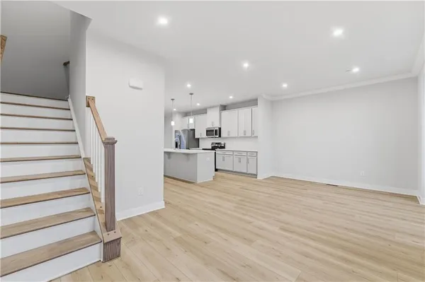 a view of kitchen with wooden floor and electronic appliances