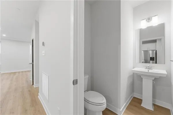 a bathroom with a sink a toilet a mirror and vanity