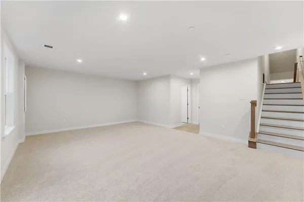 an empty room with a kitchen