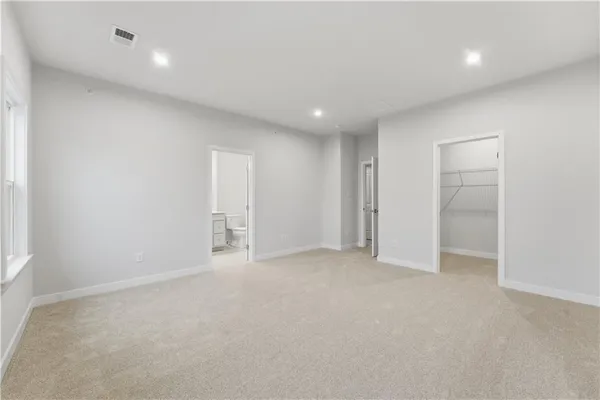an empty room with closet and bathroom