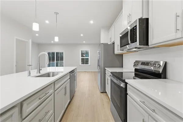 a kitchen with a sink stove and microwave