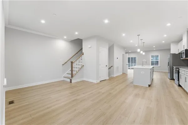 a view of a kitchen with a sink wooden floor and a kitchen