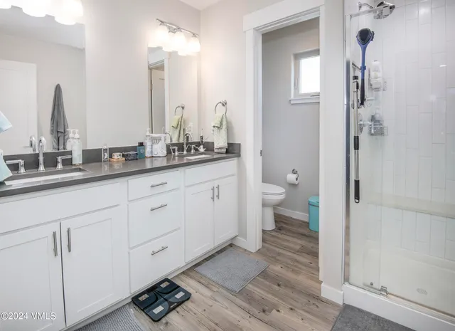 a bathroom with a double vanity sink and a mirror