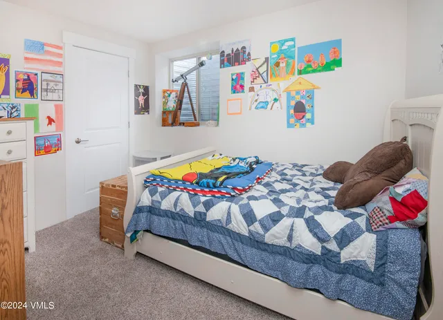 a bedroom with a bed and cabinets