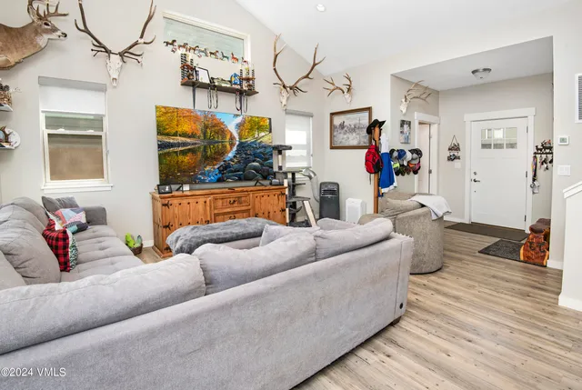 a living room with furniture and wooden floor