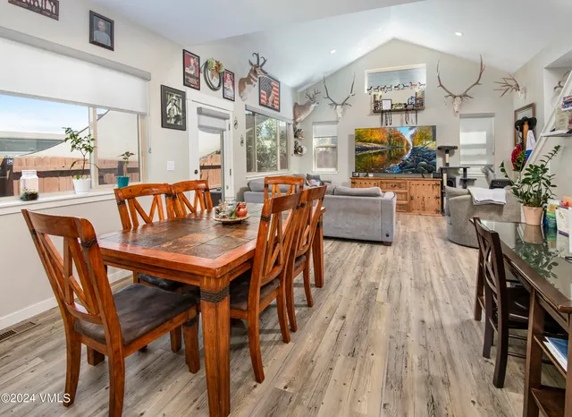 a dining room with furniture and wooden floor