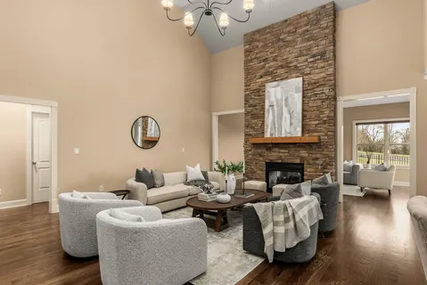 a living room with furniture kitchen view and a fireplace
