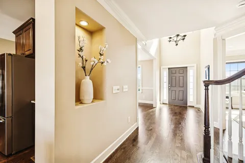 a dining room with chandelier windows and wooden floor