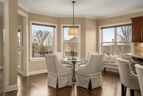 a living room with furniture a flat screen tv and a large window