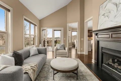a kitchen with granite countertop a table chairs stainless steel appliances and cabinets
