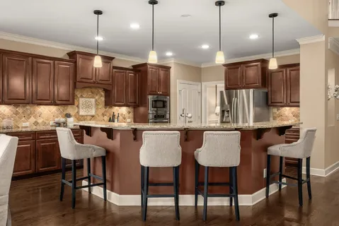 a kitchen with granite countertop wooden cabinets stainless steel appliances and a counter space