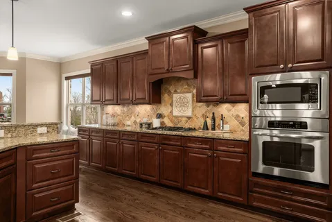 a kitchen with stainless steel appliances granite countertop a refrigerator and a sink