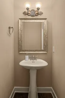 a bathroom with a tub sink and mirror