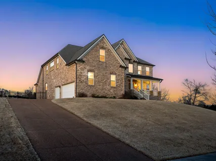 a view of a brick house with large windows