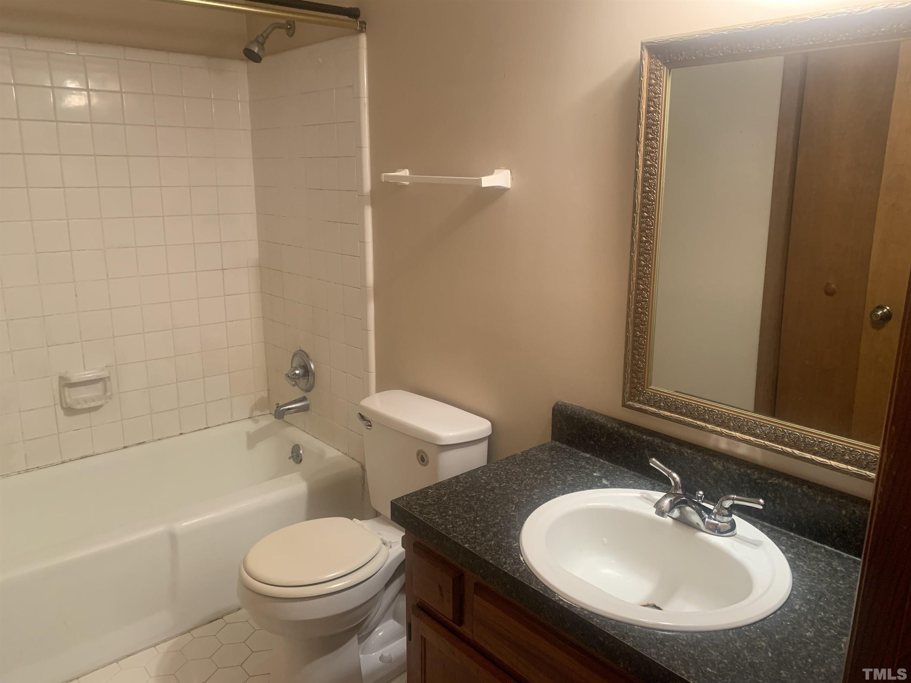 5852 Shady Grove Circle Raleigh, NC 27609 - Photo 8 of 13 a bathroom with a sink toilet and shower