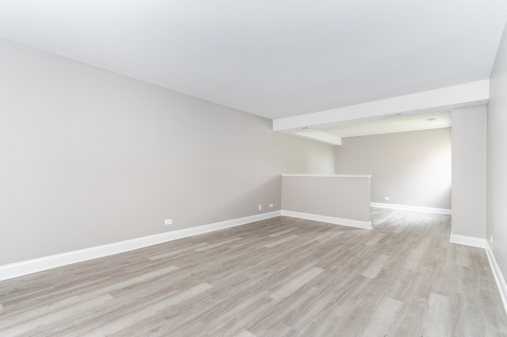 470 Raintree Court, Unit 2H Glen Ellyn, IL 60137 - Photo 15 of 22 a view of an empty room with wooden floor and a window