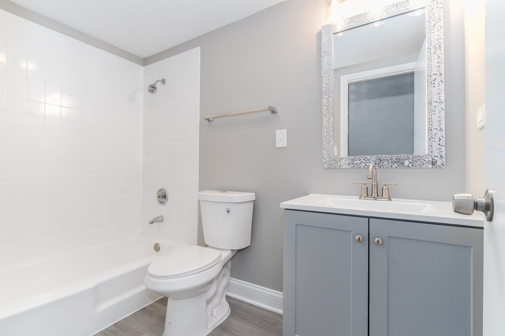 470 Raintree Court, Unit 2H Glen Ellyn, IL 60137 - Photo 16 of 22 a bathroom with a toilet sink vanity and mirror