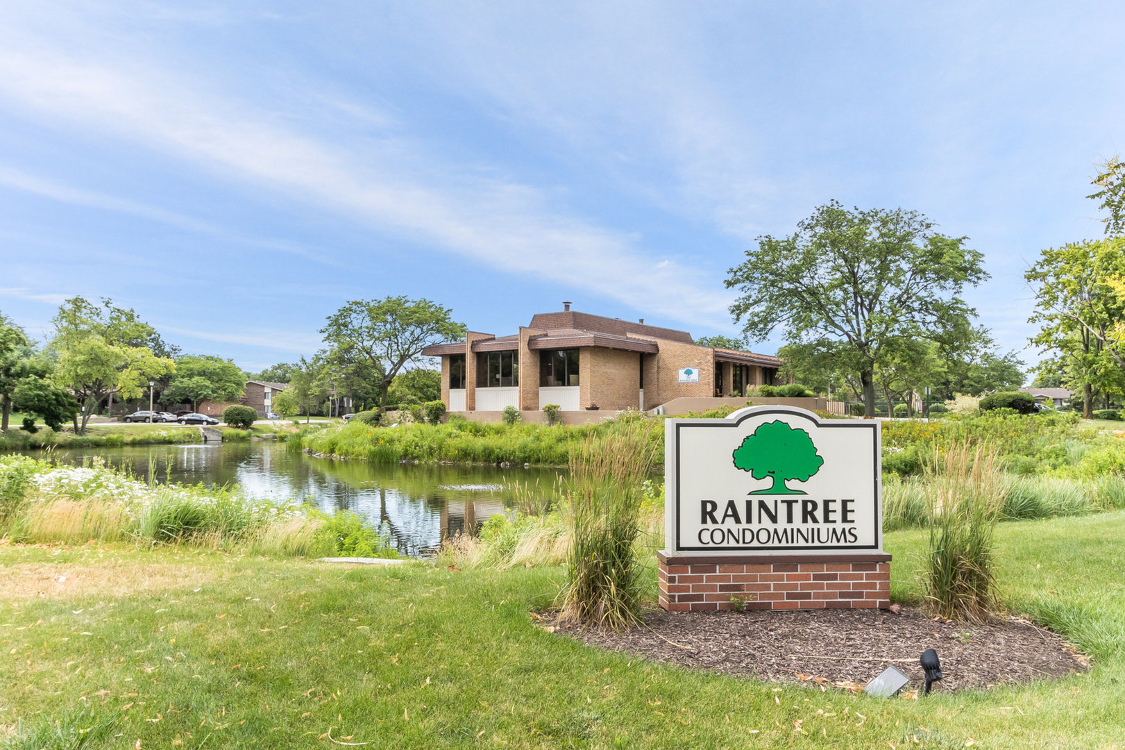 470 Raintree Court, Unit 2H Glen Ellyn, IL 60137 - Photo 21 of 22 a view of a house with a yard and a bench