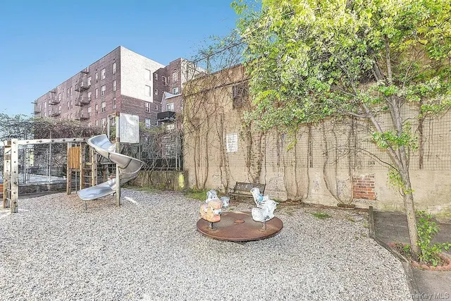 a view of a patio with a table and chairs