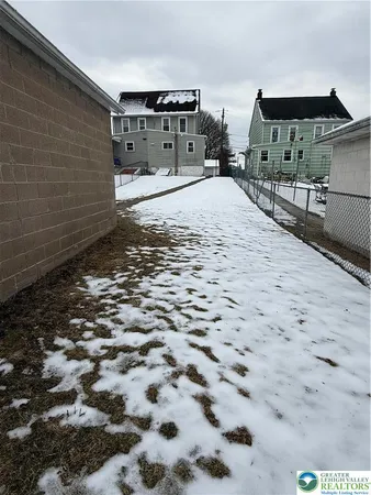 a view of a house with a snow in the background